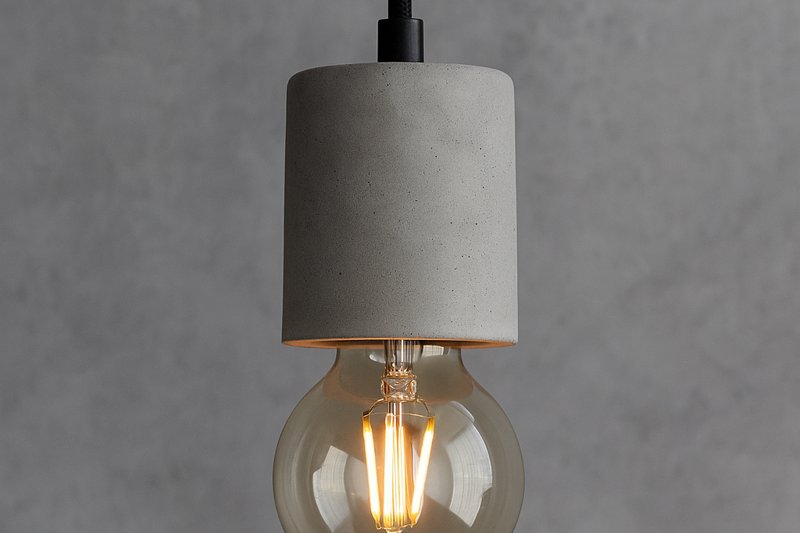 Image of a sleek DIY concrete pendant light with a minimalist cylindrical or hemispherical shade, showcasing a small, clear Omita G80 LED Edison bulb glowing warmly within its an_h form.