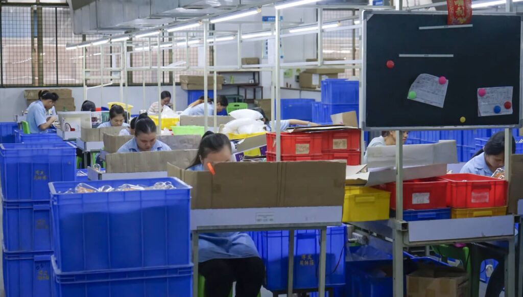 Decorative LED bulb assembly line with workers and production bins at HongYu Bulb factory