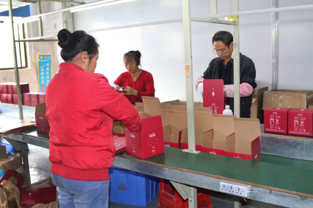 Workers preparing decorative LED bulb packaging and final packing at HongYu Bulb factory