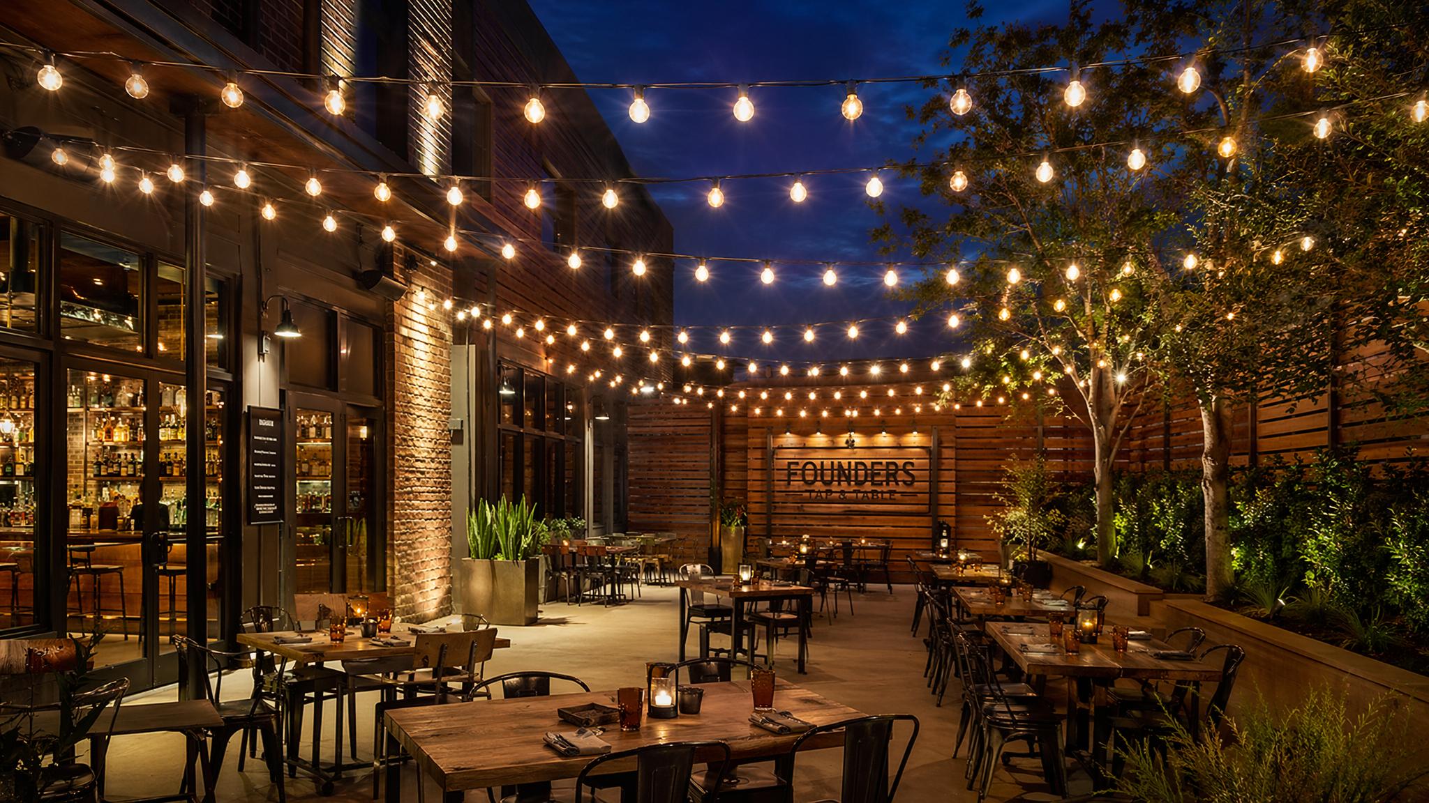 Commercial outdoor patio string lights using globe LED filament bulbs