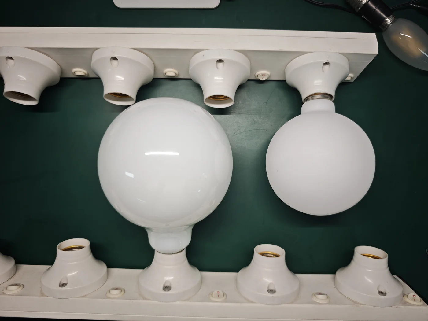 HongYu opal globe on the left with glossy reflections and a matte porcelain-style globe on the right, both switched off