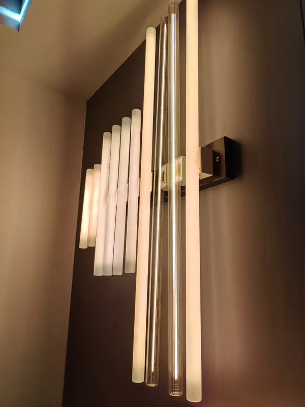 Linear bulbs arranged in wall-light fixtures
